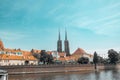 Street with cobblestone road with green trees, colorful buildings, summer cafe, Cathedral of St. John the Baptist church Royalty Free Stock Photo