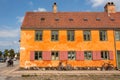 Street with cobblestones and cyclist driving past colorful house in historical style