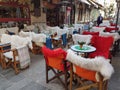 Street coffee shop tables and chairs with warm cloth in Kalari street Ioannina