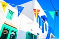 Street with colorful flags in Mykonos, Greece Royalty Free Stock Photo