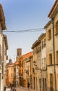 Street with colorful houses and cathedral tower in Tudela