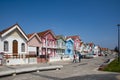 Street with colorful striped houses typical of Costa Nova, Aveiro, Portugal