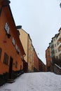 Street of colourful traditional Swedish houses in the snow in Sodermalm, south Stockholm, Sweden.