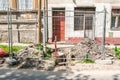 Street construction or reconstruction site of pipeline with metal industrial fence around the hole