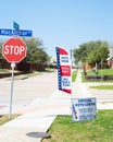 Street corner Stop and yard sign, vote banner flag show Official Vote Center in English, Spanish, Vietnamese welcome resident and