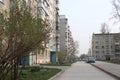 street in the courtyard of modern apartment buildings with parked cars in the city in summer