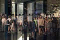 Street crowd reflected and distorted in shop window