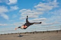 Street dancer hipster guy makes back flip with arm support on the roof outdoor. Royalty Free Stock Photo