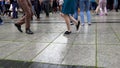 Street dancers legs perform lindyhop dance on street music day.