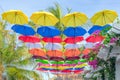 Street decorated with colorful umbrellas hanging on top side in the sky. Royalty Free Stock Photo