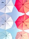 Street decorated with colorful umbrellas hanging on top side in the sky. Royalty Free Stock Photo