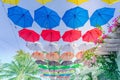 Street decorated with colorful umbrellas hanging on top side in the sky. Royalty Free Stock Photo