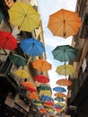 The street is decorated with colorful umbrellas