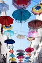 Street decorated with umbrellas of different colors. Concept of umbrellas sky Royalty Free Stock Photo