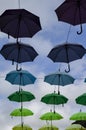 Street decoration of umbrellas, strung out at roof top height, in the Welsh royal town of Caernarfon.