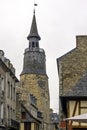 Street of Dinan with vintage architecture and clock tower of old church in Dinan, France Royalty Free Stock Photo