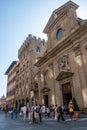 Florence ITALY - August 6, 2023 - Street with people next to the facade of the Basilica di Santa Trinita