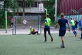 Russia, Khabarovsk - Jun 11, 2019: street domestic playing soccer. Young guys play soccer on a green grass