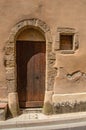 Street door made of wood on old stone wall in the ChÃÂ¢teauneuf-du-Pape Royalty Free Stock Photo