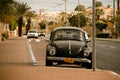 Street of Eilat with retro car and sea view with palms. Royalty Free Stock Photo