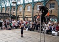 Street entertainer at Covent Garden market, London UK, entertaining the crowds during the summer holidays.