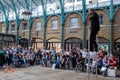 Street entertainer at Covent Garden market, London UK, entertaining the crowds during the summer holidays.