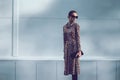 Street fashion concept - pretty elegant woman in leopard dress