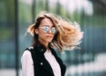 Street fashion concept. Young beautiful model in the city. Beautiful blonde woman wearing sunglasses Royalty Free Stock Photo