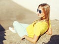 Street fashion portrait trendy young blonde woman in sunglasses