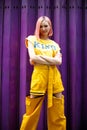 Street Fashion Woman with dying Pink Hair color wear yellow chic dress