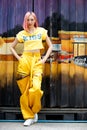 Street Fashion Woman with dying Pink Hair color wear yellow chic dress