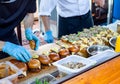 Street fast food. Cooks prepare different burgers in outdoors Royalty Free Stock Photo