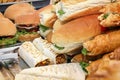 Street fast food sandwiches and burgers prepared for sale on the counter of the cafe. Royalty Free Stock Photo