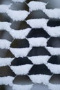 Street fence of thin mesh hawser with snowflakes accumulated in cells and half filled holes