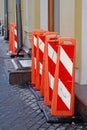 Street fences in the form of tall orange pillars of plastic