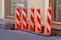 Street fences in the form of tall orange pillars of plastic Royalty Free Stock Photo