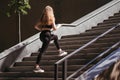 Street fitness.Young woman running on the stairs
