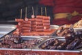 Street food with assortment of grilled sausages. Royalty Free Stock Photo