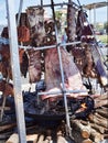 Street food with huge barbecue with many cuts of traditional Argentina wood-fired cow and pork meat on the spit Royalty Free Stock Photo