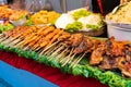 Street food market in Asia. Food counters, mini barbecue on a stick also called satey Royalty Free Stock Photo