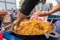 Street food sale in Nicaragua, man serving Valencian rice with bread