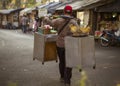 Street food seller carry his burden on the shoulder for living