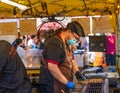 Street food seller making and cooking skewer chicken, lamb and shrimp in Asian style at the market