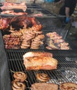 street food stall selling pork meat with skewers and sausages Royalty Free Stock Photo