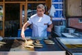 Street food vendor cooking fish