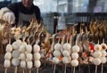 Street food vendor cooks yakitory and sweet rice balls on the open fire Royalty Free Stock Photo