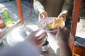 Street food vendor handing a bowl of bakso