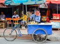 Street food vendor with his tricycle as food stall, in the city centre, Phnom Penh, Cambodia. August 30, 2015
