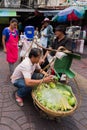 Street food vendor making mango salad in Chinatown, Bangkok, Thailand