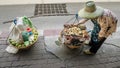 Street food vendor with shoulder pole for transportation in a central district of Bangkok, Thailand